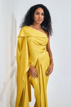 Electric yellow asymmetric dress featuring drape detailing with a flare trail on one side. - Aza Fashions Asymmetrical Cocktail Dress With Draped Sleeves, Asymmetrical Dress With Draped Sleeves For Party, Asymmetrical Party Dress With Draped Sleeves, Asymmetrical One Shoulder Dress With Draped Sleeves, Party Asymmetrical Dress With Draped Sleeves, Asymmetrical Dress With Draped Sleeves, Elegant Yellow Dress With Asymmetrical Neckline, Yellow Draped Cocktail Dress, Yellow Draped Fitted Dress