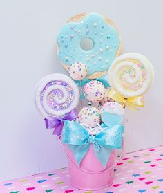 a pink basket filled with donuts and candy