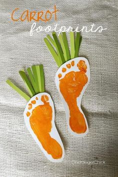 carrot footprints made out of paper on top of a cloth covered surface with the words carrot footprints painted on it