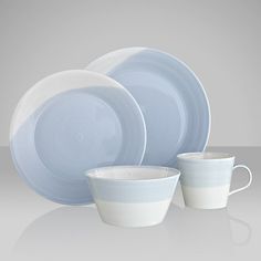 a set of blue and white dishes with cups