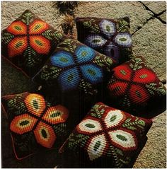 several knitted balls are sitting on the ground