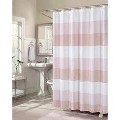 a pink and white shower curtain in a bathroom