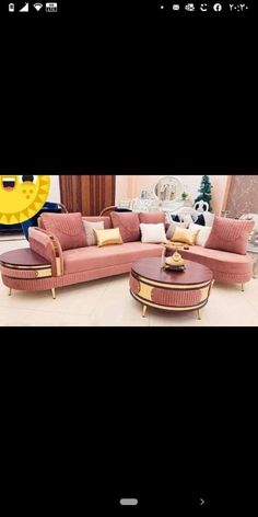 a living room with pink couches and gold accents on the table, along with other furniture