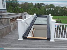 an open window on the side of a wooden deck