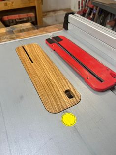 two pieces of wood sitting on top of a table next to a yellow sticker