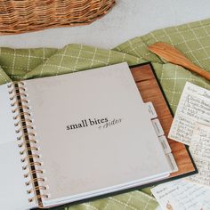 an open notebook sitting on top of a green blanket