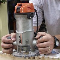 a man is working with an electric sander