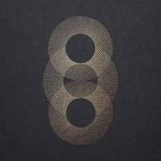 an image of two circles in the middle of a black background with gold foil on it