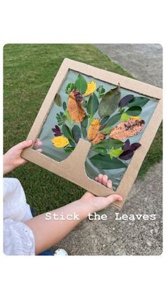 a person holding up a piece of paper with leaves on it and the words stick the leaves