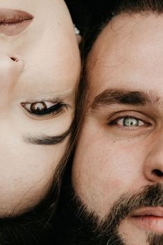 a man with his face painted to look like a human head next to a woman's face