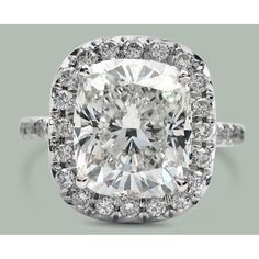 a cushion cut diamond ring with halos around it