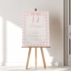 a welcome sign on an easel in front of a door