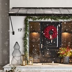 a christmas wreath on the front door of a house