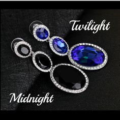 Three dramatic evening colored Austrian crystals in graduated sizes are surrounded by a halo of white CZ stones. The dark colored crystals are complemented by the silver plating and shining white halo. The sparkling crystals and the length of 2.5 inches creating a showstopping look. The perfect pair for a night on the town. Available in Midnight or Twilight Occasions: Special Evenings, Bridal, Holiday, Birthday Materials: 14K White Gold Plated Alloy Stone: Austrian Crystal and Cubic Zirconia Siz Oval Crystal Earrings For Party, Elegant Blue Earrings With Stones, Formal Sapphire Crystal Earrings, Elegant Blue Stone Earrings, Dazzling Blue Crystal Earrings, Crystal Rhinestone Jewelry For Prom, Oval Jewelry With Sparkling Stones For Party, Sparkling Blue Jewelry For Evening, Blue Sparkling Jewelry For Evening