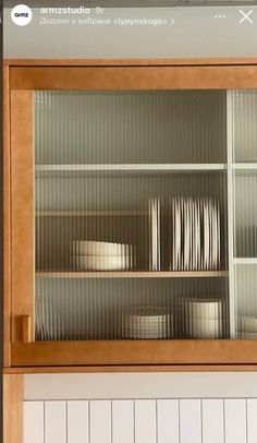 a wooden cabinet filled with lots of dishes