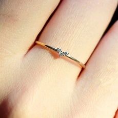 a woman's hand with a diamond ring on it