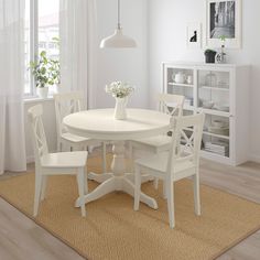 a white table and chairs in a room