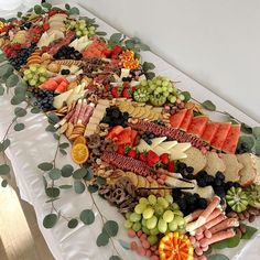 a long platter filled with lots of different types of fruits and veggies