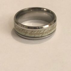 a wedding ring with the words happily married written on it, sitting on a white surface