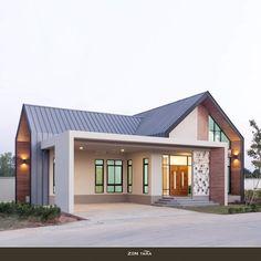 a modern house with a metal roof and two car garages in the front yard