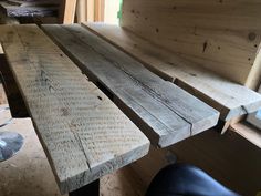 two wooden benches sitting next to each other in a room