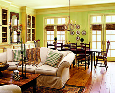 a living room filled with furniture and green walls