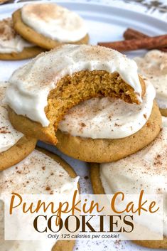 several cookies with white frosting and cinnamon sticks