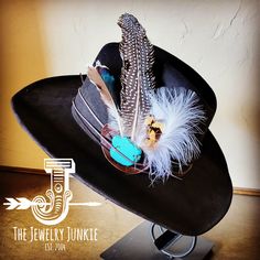 If you’re looking for the perfect accessory to complement your favorite hat, look no further. The Genuine Leather Hat Band accented with Turquoise and Feathers by The Jewelry Junkie is absolutely everything that you need. Not only is it easy to incorporate into any and all outfits, but the genuine leather immediately elevates whatever it is you’re wearing. Genuine Leather Oval Base is Sourced and Hand-Made in Texas Leather base measures 2.5x3.5 Inches Genuine Howlite Turquoise stone Stone will r Luxury Brimmed Hat Bands For Kentucky Derby, Luxury Vintage Hat Bands For Western-themed Events, Luxury Country Hat Bands For Kentucky Derby, Luxury Flat Brim Hat Bands For Kentucky Derby, Luxury Western Black Hat Bands, Luxury Western Fedora Hats, Luxury Country Style Hat Bands For Kentucky Derby, Elegant Luxury Hat Bands For Kentucky Derby, Luxury Western Style Top Hat For Festivals