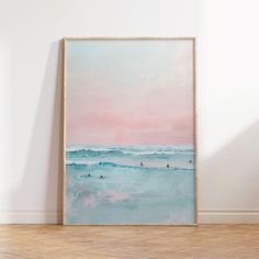 a painting hanging on the wall above a wooden floor