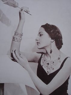 a woman is holding a feather in her hand