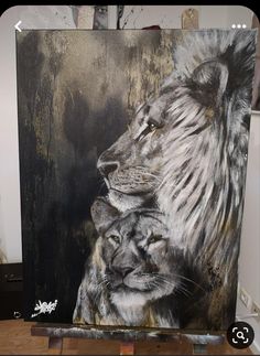 a painting of two lions sitting next to each other on a easel in front of a wall