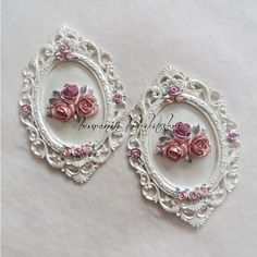 two white frames with pink flowers on them