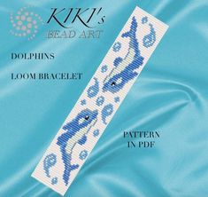 a cross stitch bookmark with the words kiki's bead art dolphins loom bracelet pattern in blue