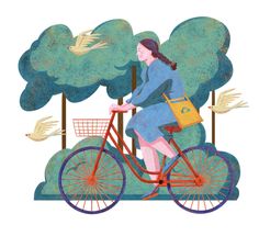 a woman riding a bike with a basket on the front and birds flying around her