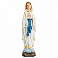 a statue of the virgin mary is shown in white and gold with blue trimmings