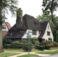 a white house with brown shingles on the roof