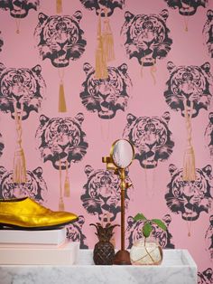 a wallpapered room with gold accents and a pink tiger pattern on the wall