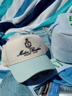 Motor Boatin' Yacht Club Trucker In collaboration with Aubrey Schoenekase! Perfect hat for ALL summer long! Especially for you lake goers! Baby blue vintage with navy embroidery Summer Baseball Cap With Embroidered Logo And Short Brim, Blue Cotton Trucker Hat For The Beach, Retro Blue Trucker Hat For Beach, Blue Cotton Trucker Hat For Summer, Summer Blue Cotton Trucker Hat, Vintage Baseball Cap For Beach In Summer, Blue Baseball Cap With Short Brim For Beach, Blue Short Brim Baseball Cap For The Beach, Blue Short Brim Baseball Cap For Beach