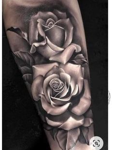 a black and white rose tattoo on the arm