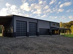 two garages are shown in the middle of a gravel lot with grass and trees behind them