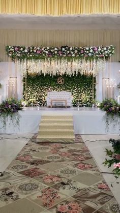 an aisle decorated with flowers and greenery