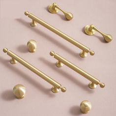 brass handles and knobs on a pink background