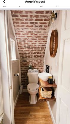 a bathroom with brick walls and wooden floors