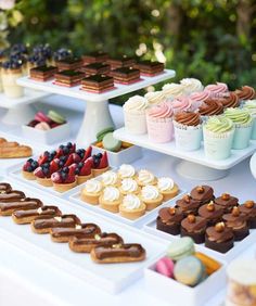 a table topped with lots of different types of desserts