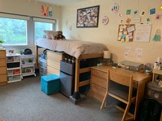 a dorm room with desk, bed and toys