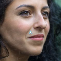 a close up of a woman with a nose piercing