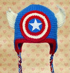 a crocheted captain america hat with wings and a star on the front,