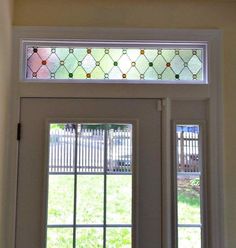 an open door with a stained glass window above it