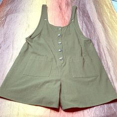 Urban Romantics Size Large New Without Tags Olive Green Button Up Sleeveless Romper Smoke Free Home Fitted Sleeveless Overalls With Button Closure, Sleeveless Khaki Jumpsuit With Pockets, Sleeveless Khaki Jumpsuits And Rompers For Summer, Fitted Sleeveless Shortalls With Pockets, Slim Fit Sleeveless Shortalls With Pockets, Summer Bib Front Shortalls With Button Closure, Green Button-up Jumpsuits And Rompers, Workwear Overalls With Bib Front And Buttons, Button-up Overalls With Pockets For Summer