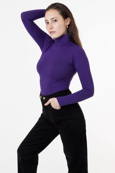 Our classic turtleneck now available in our favorite neutrals and statement bright colors to match our garment dye collection. A tight, fitted turtleneck made of high quality cotton spandex with a full fold-over turtleneck to keep you warm all season long. This top features a mid-length that can still be tucked into high waisted styles and is ideal for layering without adding bulk underneath your favorite sweaters and jackets. We recommend sizing up if you prefer a less fitted look. Please note, Purple Turtleneck, Paloma Elsesser, Burgundy Dahlia, Classic Turtleneck, La Outfits, Yellow Tops, Los Angeles Apparel, Turtleneck Style, Garment Manufacturing